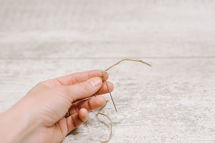 thread twine through an embroidery needle