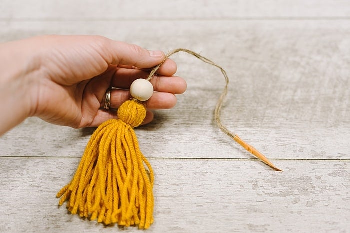 add beads to wood bead tassel ornament