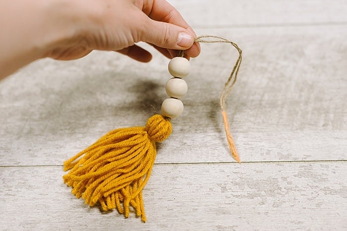 add wooden beads to Christmas tassel