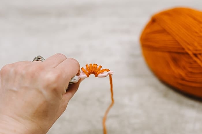 wrap yarn around pom pom maker