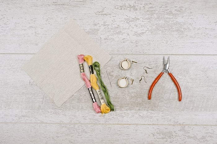 Supplies to make embroidery hoop earrings.