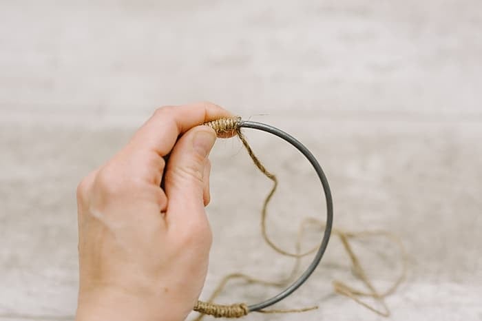 wrap twine around the metal hoop, gluing as you go