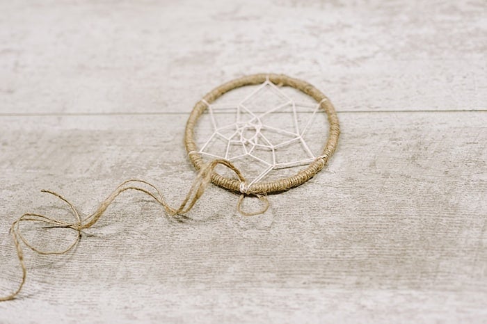 add twine tails to the bottom of the dream catcher