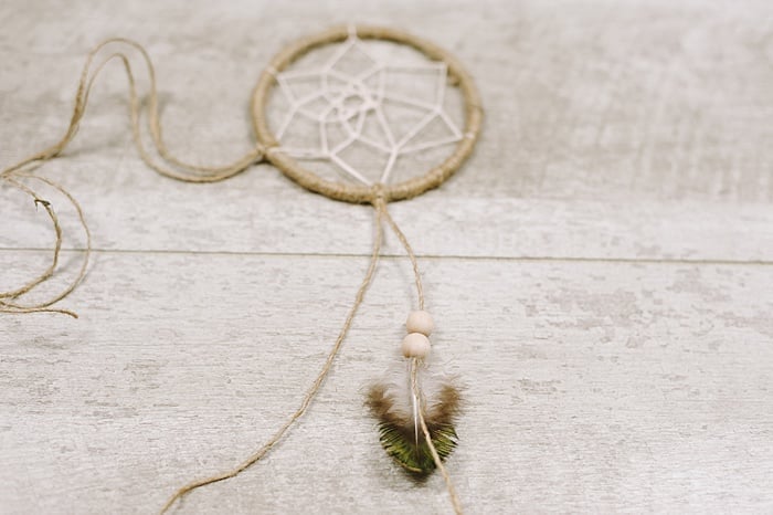 add beads and feathers to the bottom of the dreamcatcher tails
