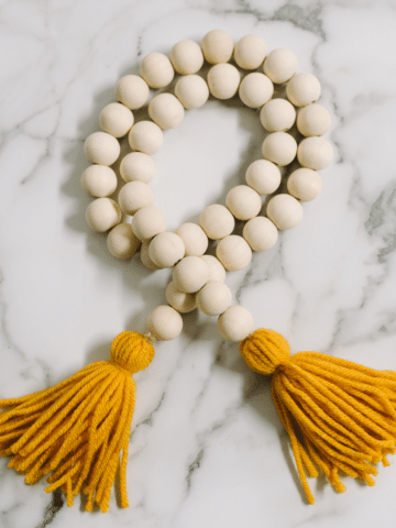 How to Make a Wood Bead Garland with Yarn Tassels