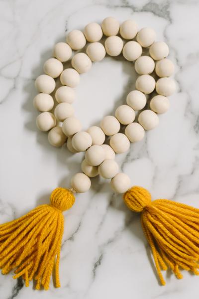How to Make a Wood Bead Garland with Yarn Tassels