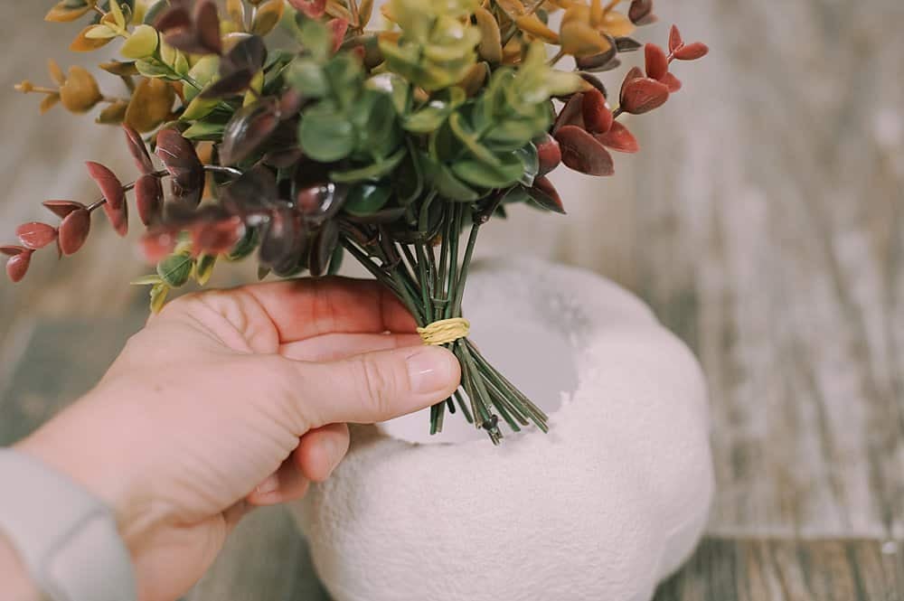 wrap rubber band around stems of fake eucalyptus