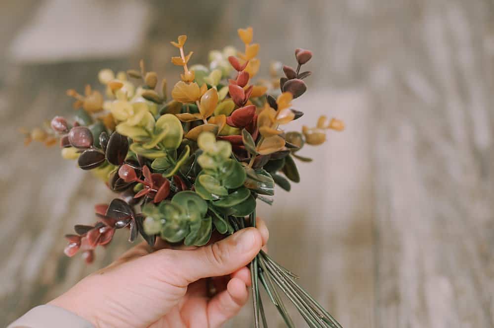 gather fake eucalyptus together into a bundle