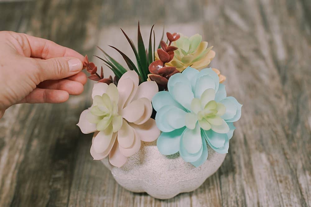 add a few sprigs of faux eucalyptus to finish off the faux succulent pumpkin