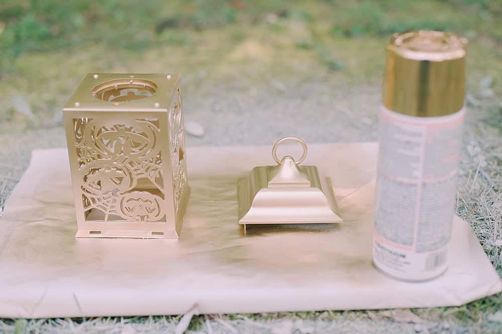 paint outside of lanterns using metallic gold spray paint