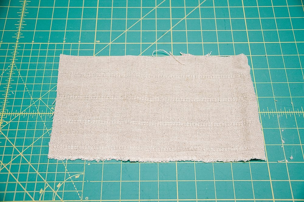 Fabric rectangle laying on a sewing mat.