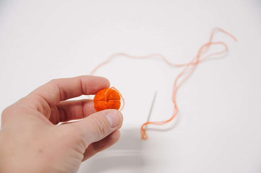 Making a mini felt ball pumpkin.