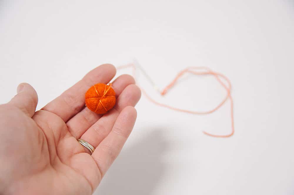 tiny felt ball turned into a pumpkin
