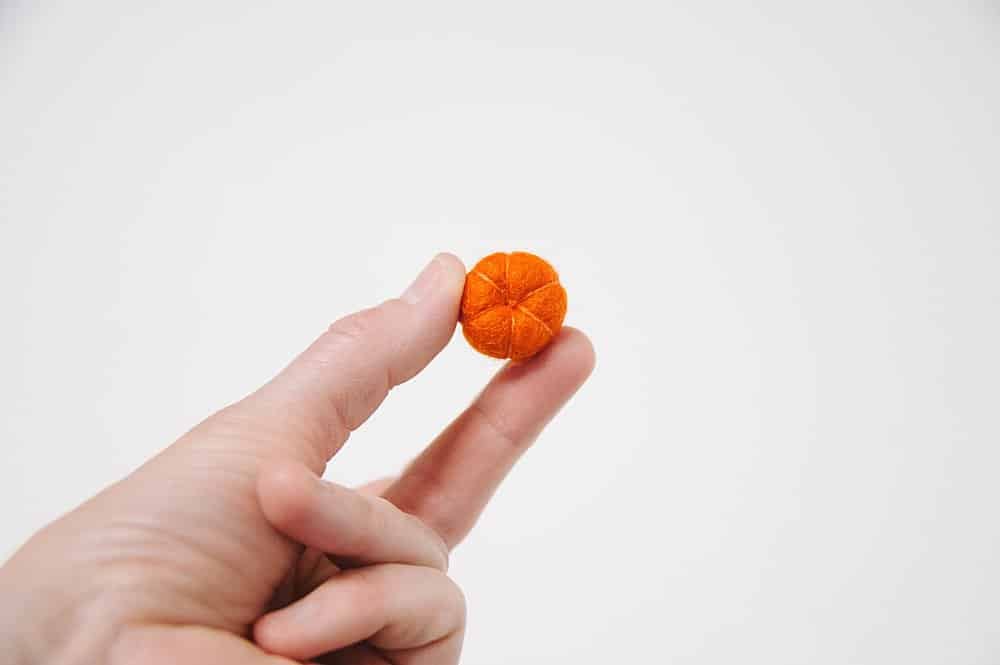 The bottom of a felt ball pumpkin.