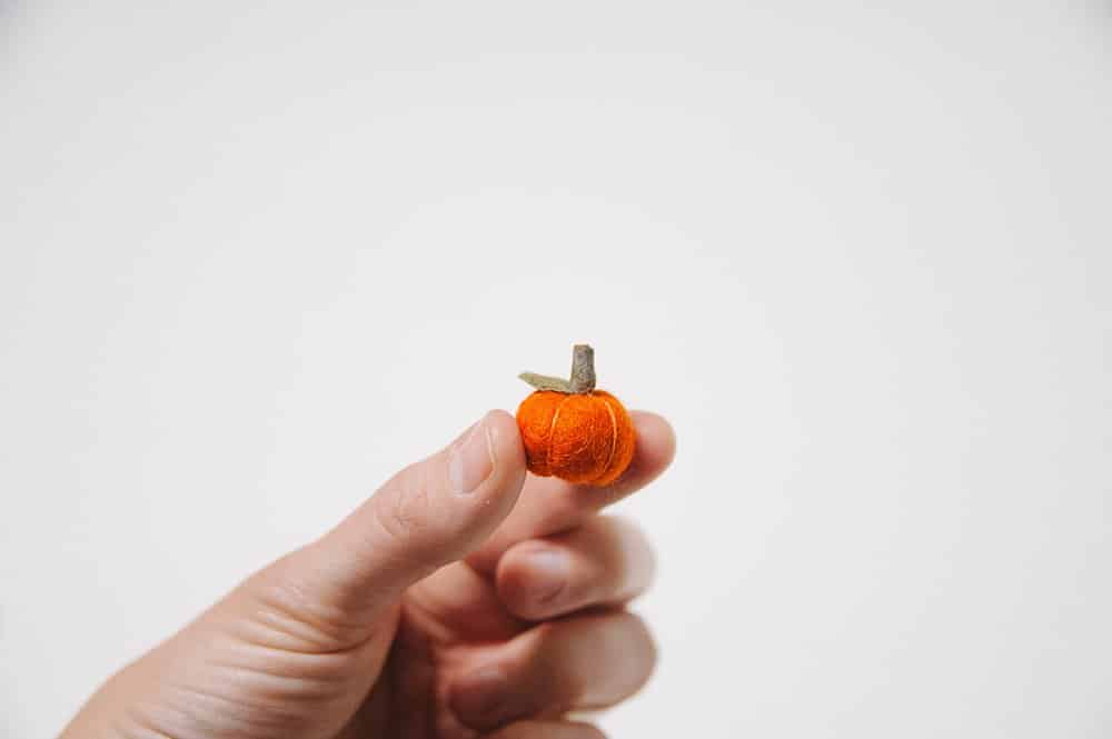 diy miniature felt ball pumpkin with leaf and wooden stem
