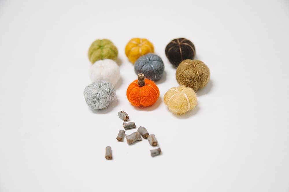 hot glue stems onto felt ball pumpkins