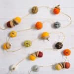 fall garland idea made with felt ball acorns and felt ball pumpkins.