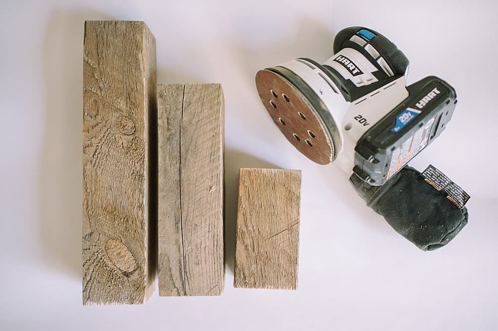 smooth out wooden posts with orbital sander