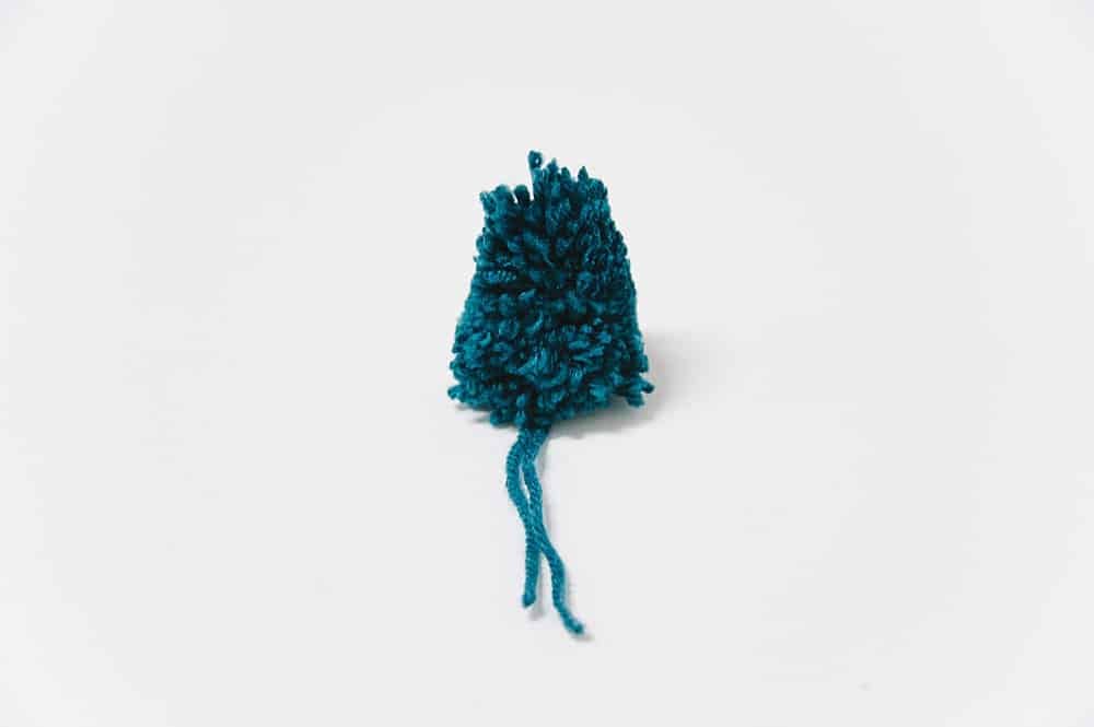 trim yarn pompom into cone shape