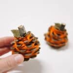 How to make yarn wrapped pinecone pumpkins for fall.