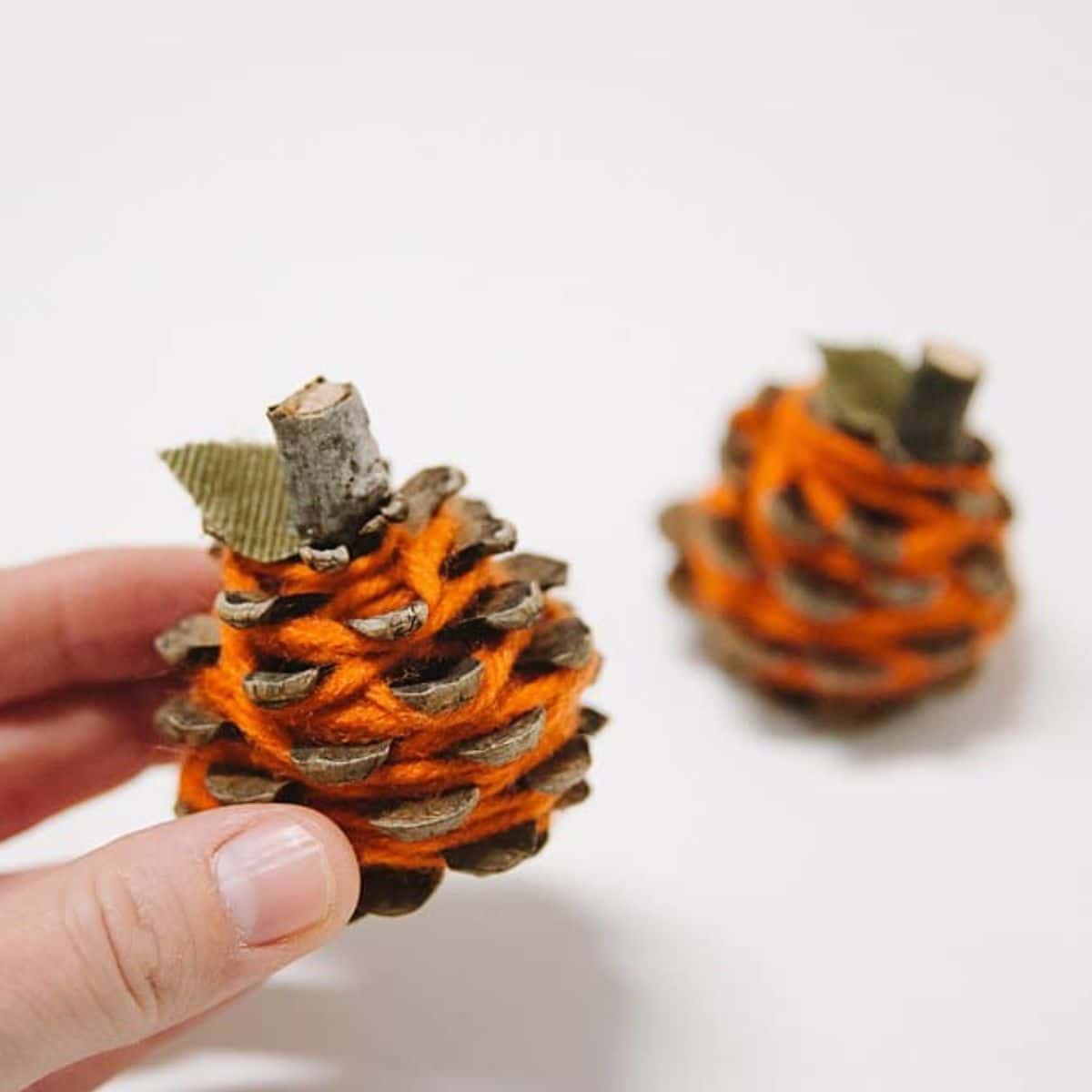 How to make yarn wrapped pinecone pumpkins for fall.