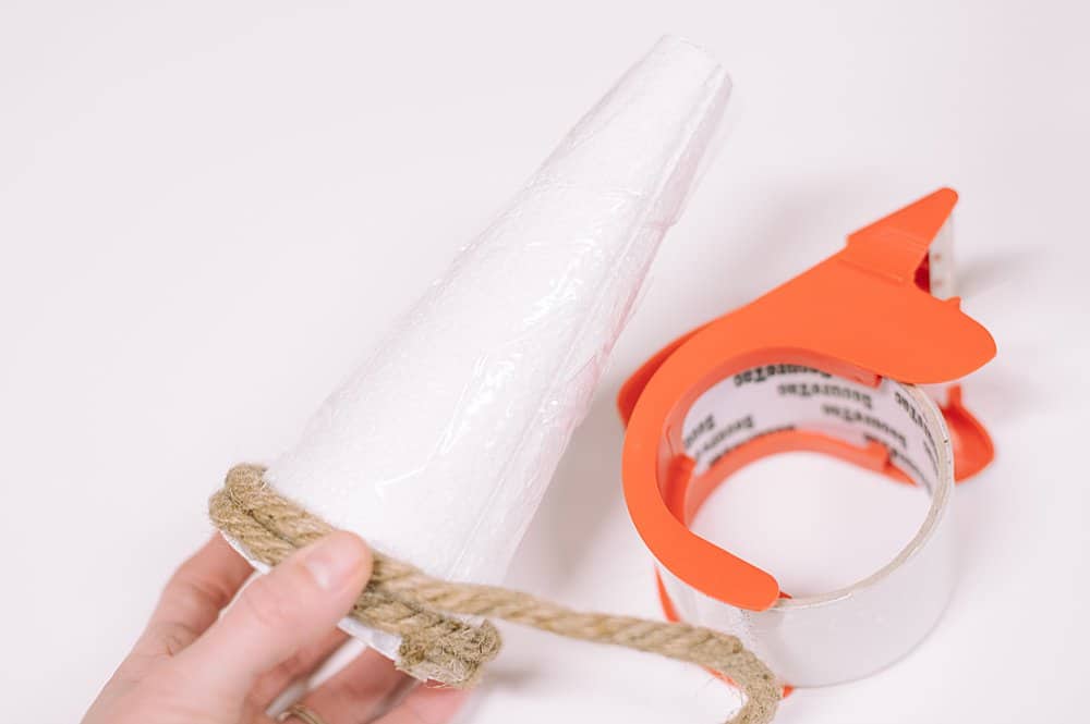Wrap cone in packing tape to protect the styrofoam from the hot glue.