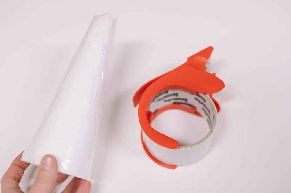 Cover styrofoam cone in packing tape to protect from hot glue.
