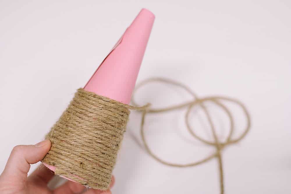 Keep wrapping twine around paper cone to make a christmas tree.