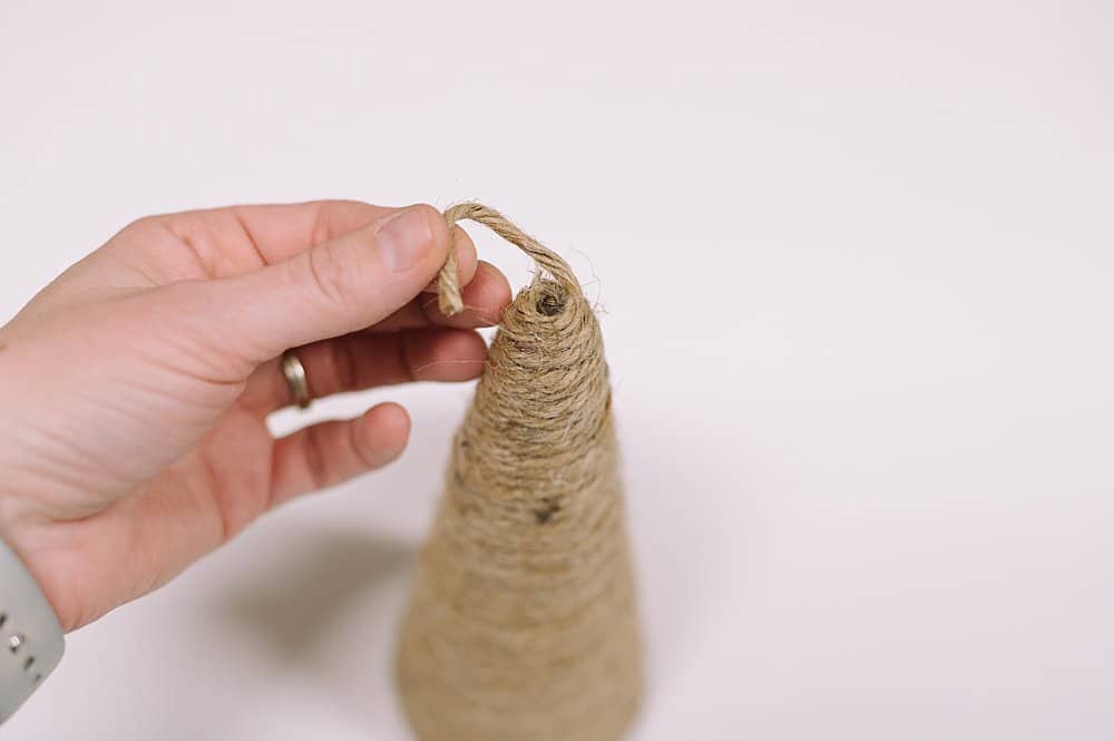 Tuck the top of the twine into the hole and glue.