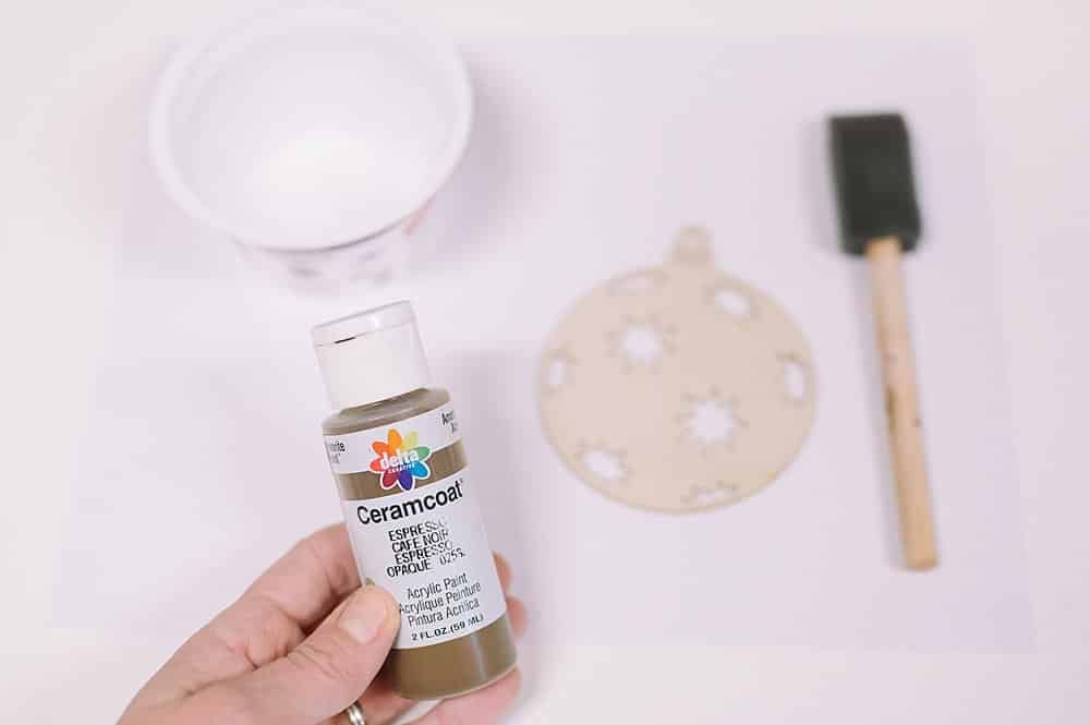 brown paint can be used to do a faux "stain" on wood christmas ornaments