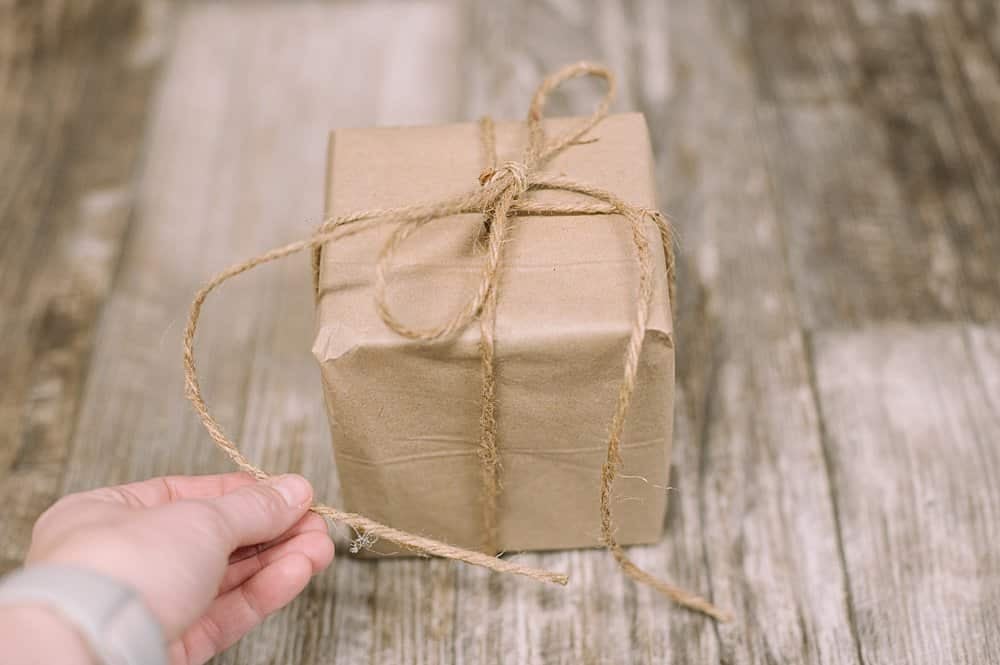 tie a bow with twine at the top of a christmas present