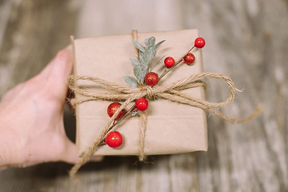 add some red berries and faux greenery to your gift