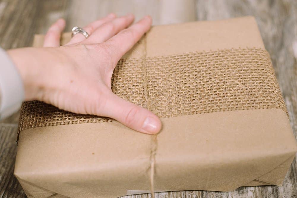 add twine to burlap ribbon and kraft paper wrapping presents