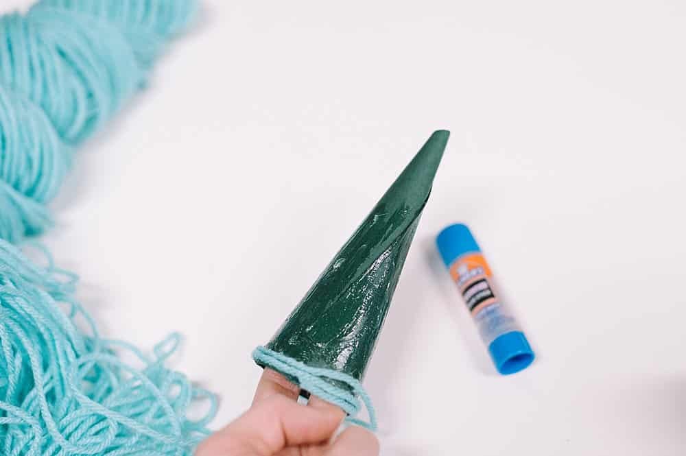 put glue stick on paper cone to make mini christmas trees