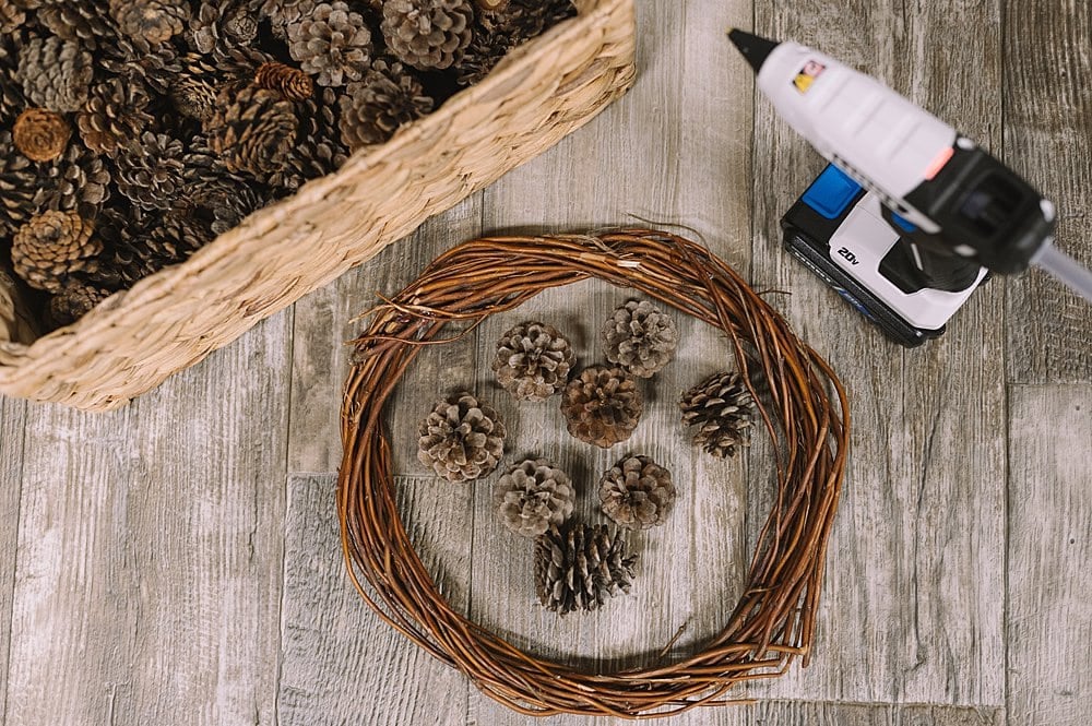 Supplies needed to make a pinecone wreath.