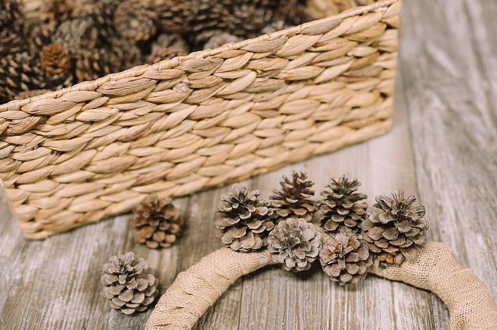 hot glue pinecones onto the wreath