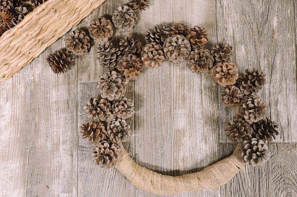 Pine cones hot-glued onto the wreath.
