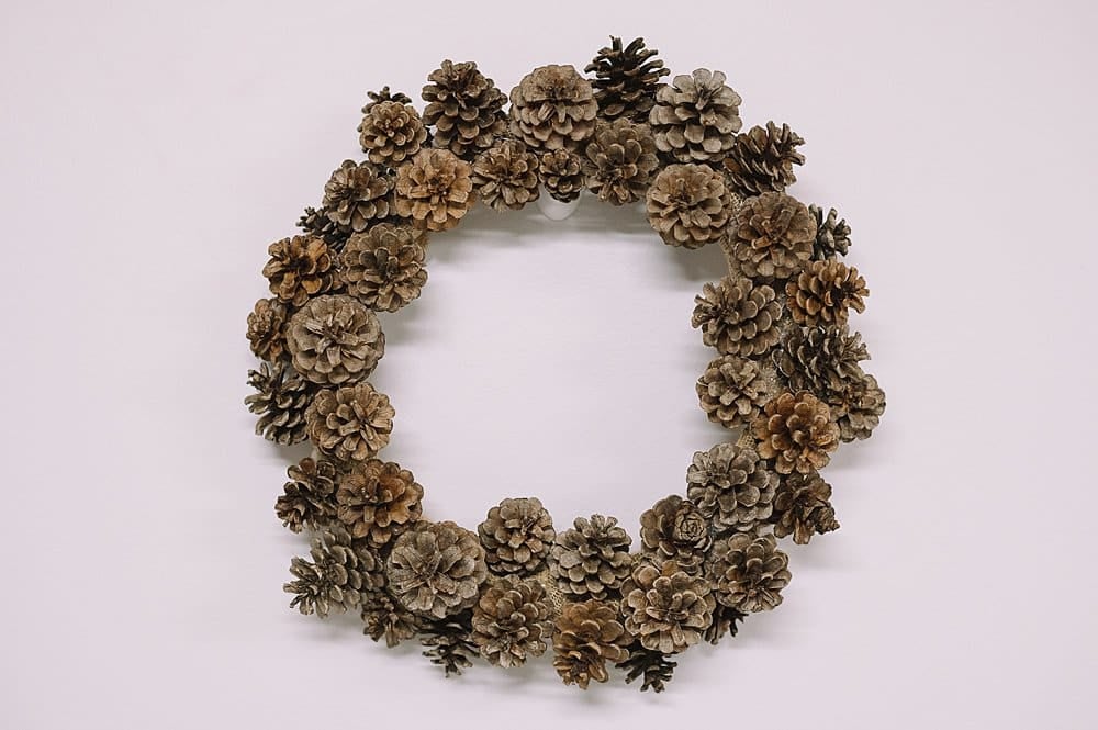 A pinecone wreath ready to hang.