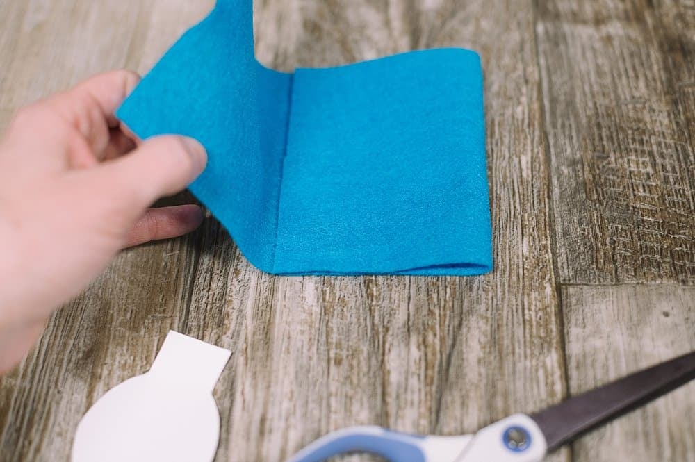 fold felt fabric into three layers to be able to cut three lightbulbs at one time