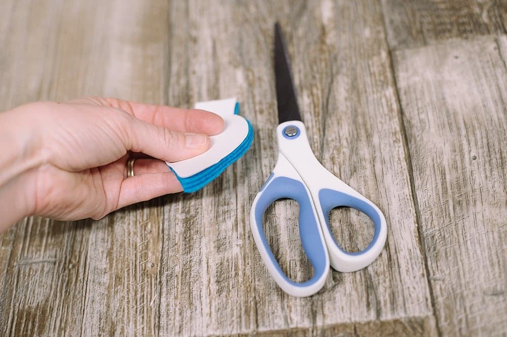 Cut out three felt lightbulb shapes by cutting around the paper template.