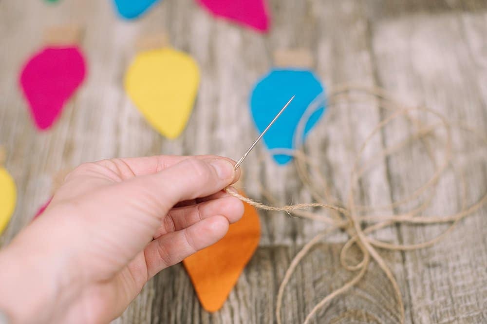 thread twine through each felt lightbulb