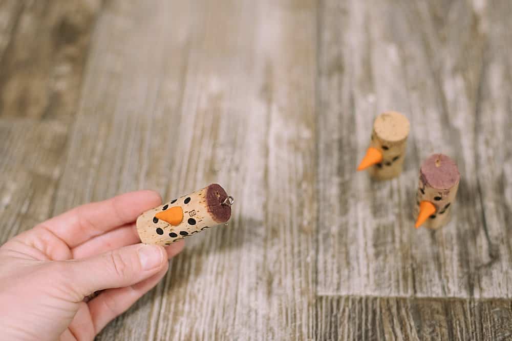 screw a small metal hook into the top of the cork