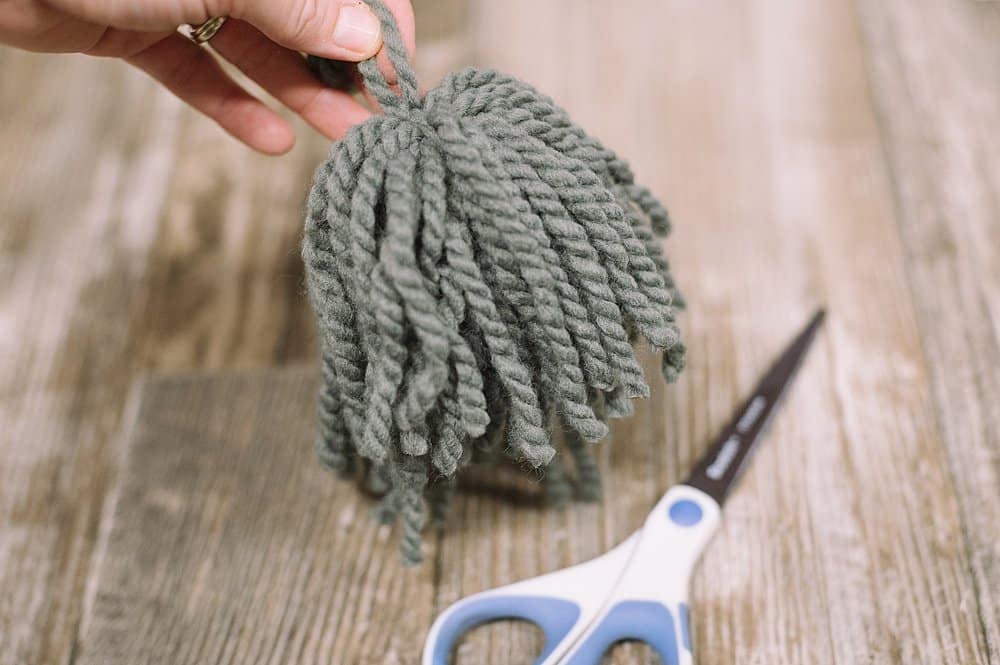 A yarn tassel that will become the beard of a DIY gnome.