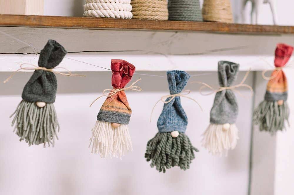 how to make a diy gnome garland for Christmas using yarn and sock gnomes