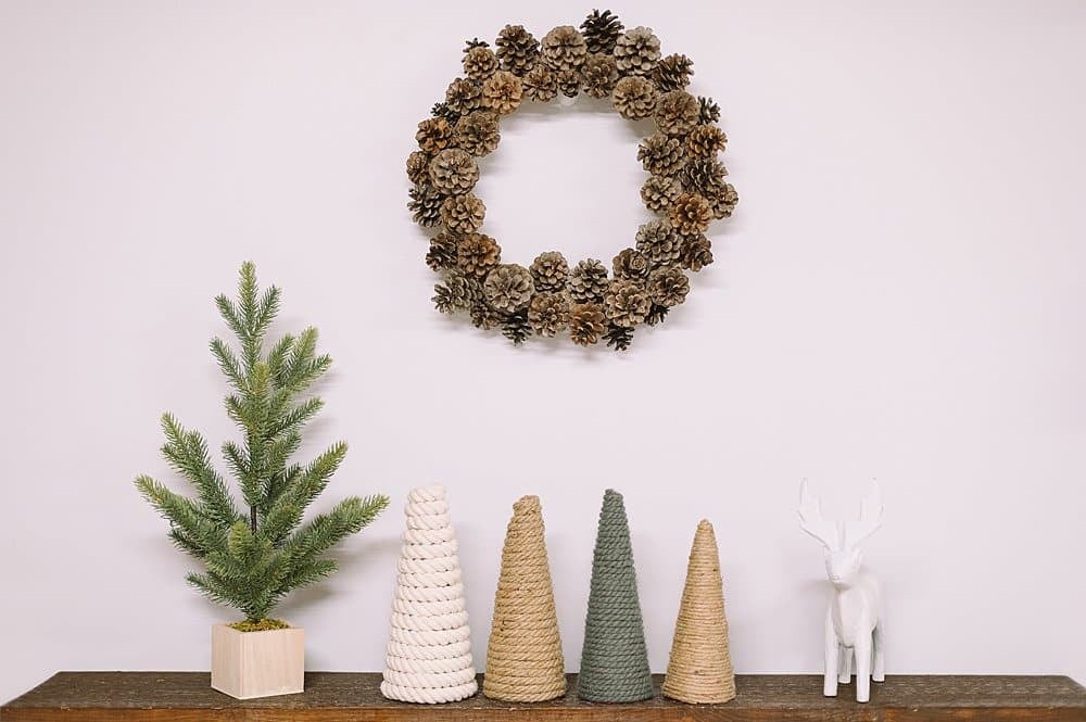A pinecone wreath hanging above a mantel.