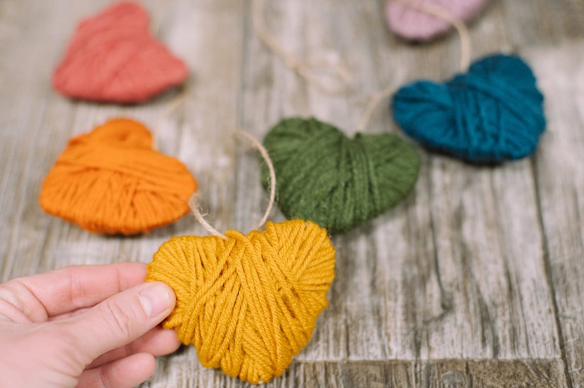 A garland made from heart shapes wrapped in yarn.