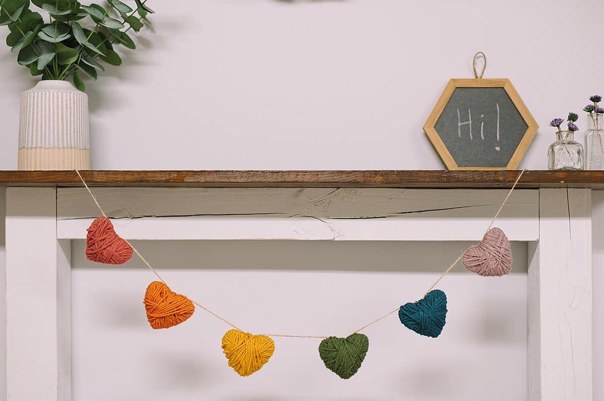 A garland made with heart shapes wrapped in yarn.
