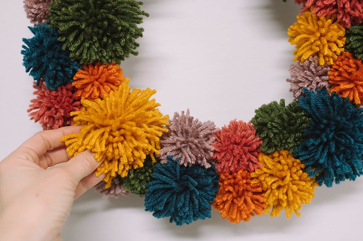how to make a rainbow pom pom wreath