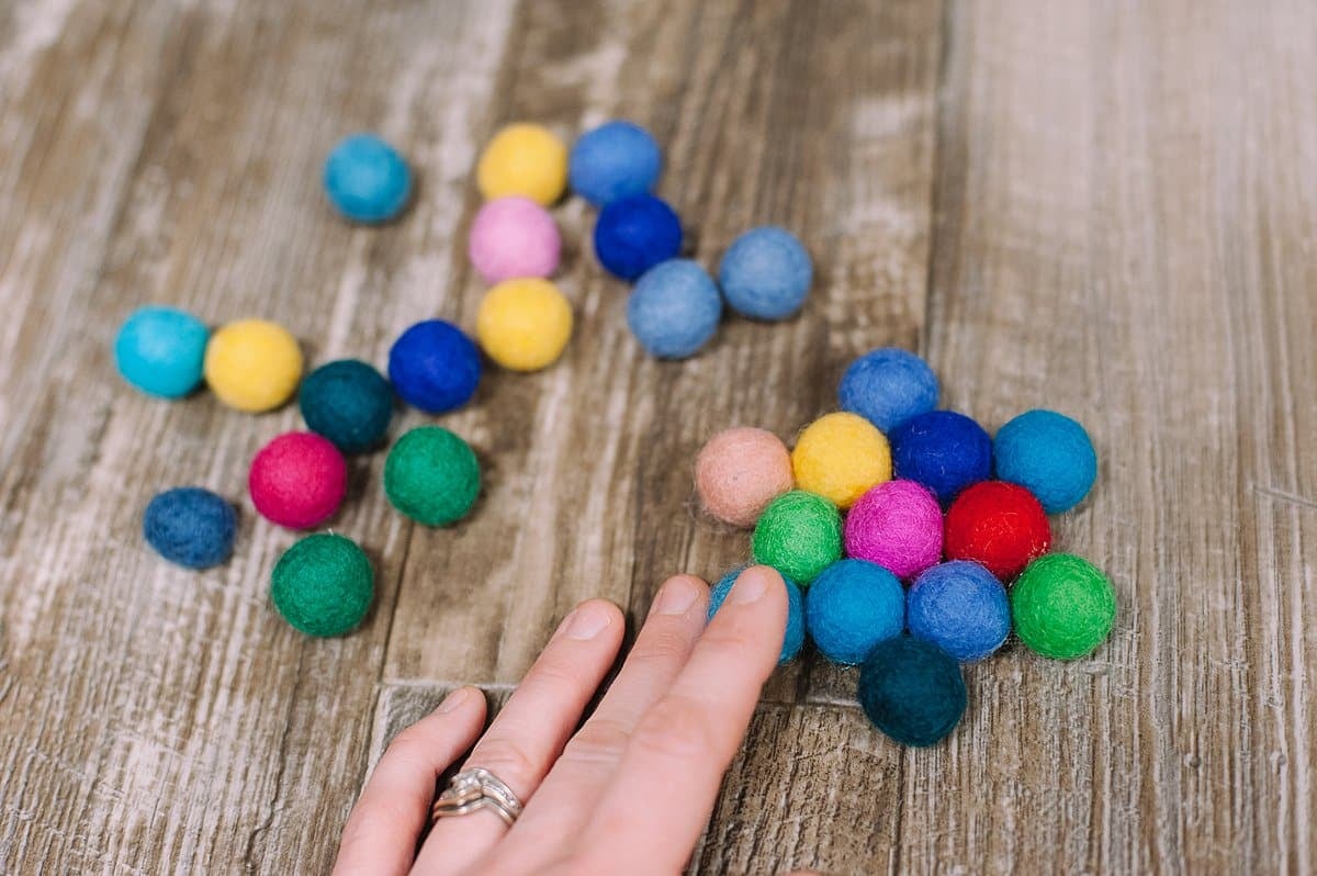 continue adding outer rings of felt balls to make the trivet bigger