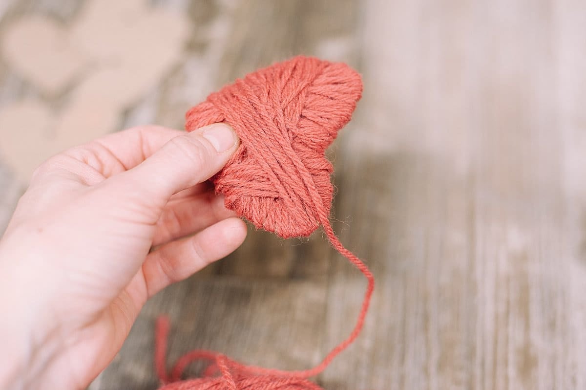 Wrap yarn around cardboard heart cutout shape.